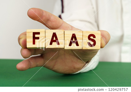 In the man's hand are cubes with the inscription - FAAS 120429757