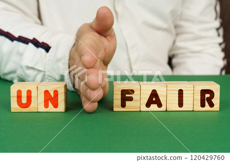 A man separates the cubes with the inscription - UN FAIR 120429760