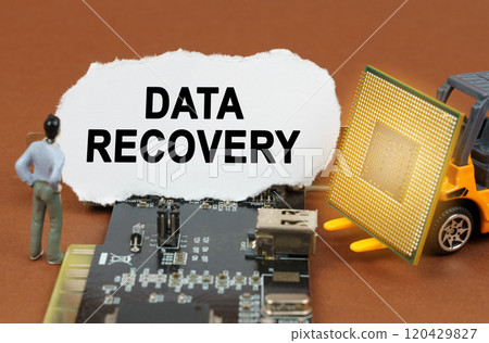 On the board with microcircuits lies a paper plate with the inscription - Data Recovery 120429827