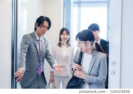 Business people getting on an elevator in the office 120429898