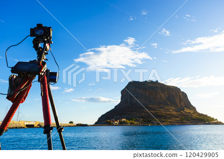 Camera on tripod and Monemvasia island 120429905