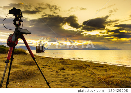 Camera on tripod and shipwreck 120429908