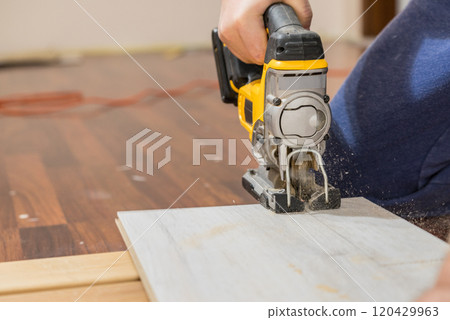 Person cutting floor panels 120429963