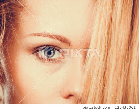 Blonde woman holding her long tangled hair 120430061