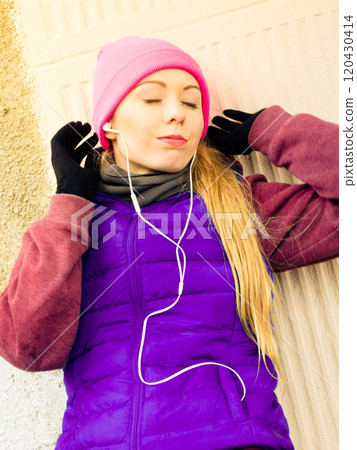 Woman wearing warm sportswear relaxing after exercising 120430414