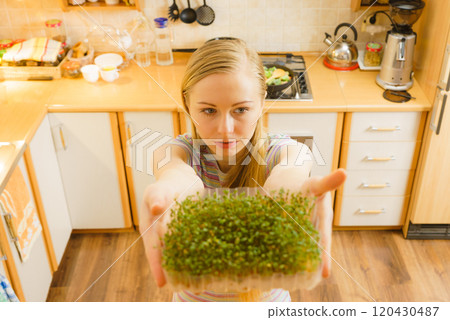 Happy woman holding cuckooflower cress 120430487