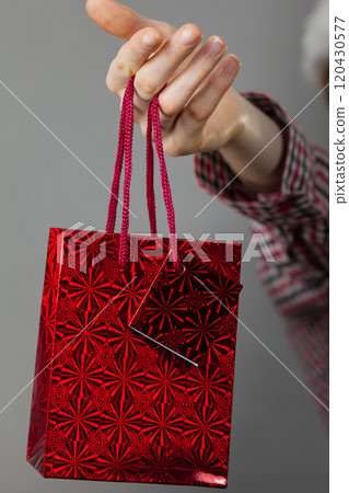 Woman holding gift shopping bag 120430577