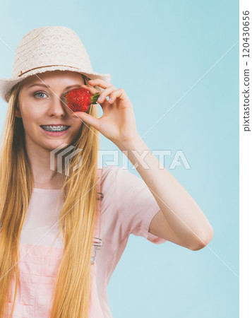 Happy woman holding strawberries 120430656