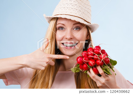 Happy woman holding radish 120430662