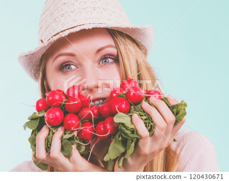 Happy woman holding radish Happy woman holding radish 120430671