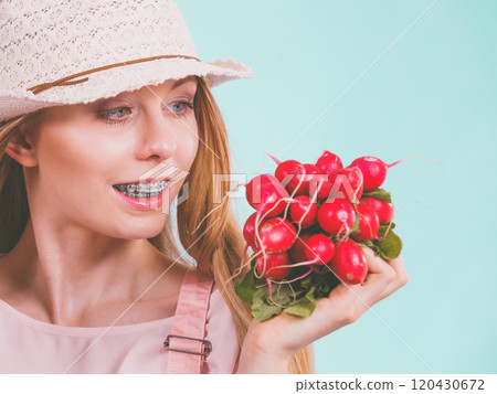 Happy woman giving radish 120430672