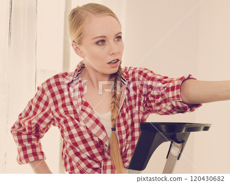 Close up of unhappy woman on ladder 120430682