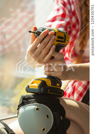 Woman adjusting her drill 120430701