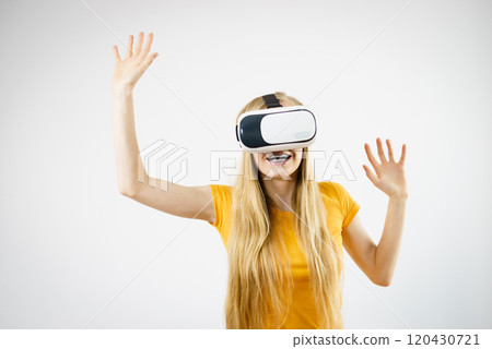 Girl wearing virtual reality goggles. 120430721
