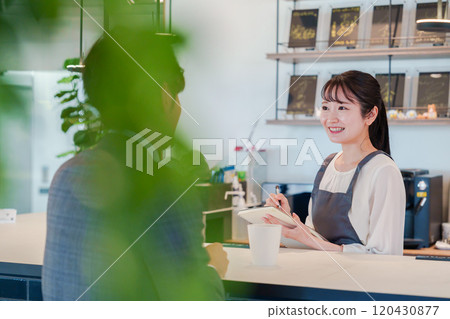 A woman and a businessman working in a stylish cafe 120430877