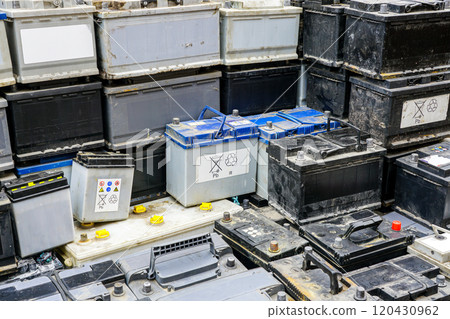 Stack of many used car batteries for recycling in a hazardous waste facility 120430962
