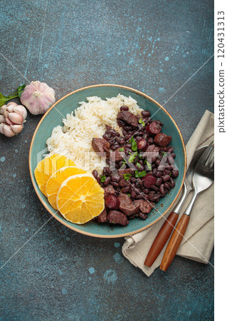 Feijoada, traditional brazilian stew with black beans, rice, and orange slices, top view 120431313