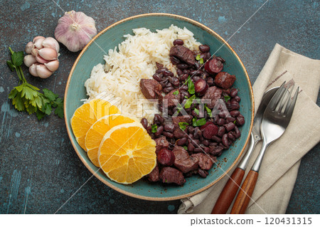 Feijoada, traditional brazilian stew with black beans, rice, and orange slices, top view Feijoada, traditional brazilian stew with black beans, rice, and orange slices, top view 120431315