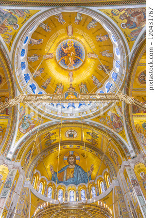 The intricate dome of the Church of Saint Sava showcases stunning gold and colorful murals, depicting religious figures in a captivating blend of artistry and spirituality. The intricate dome of the Church of Saint Sava showcases stunning gold and colorful murals, depicting religious figures in a captivating blend of artistry and spirituality. 120431767