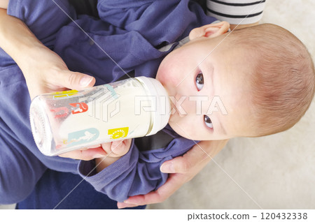 Asian baby drinking milk from a baby bottle 120432338
