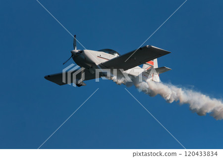 Stunt aerobatic plane performing stunts in air Stunt aerobatic plane performing stunts in air 120433834