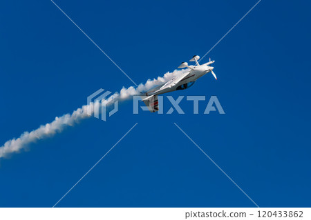 Stunt aerobatic plane performing stunts in air 120433862
