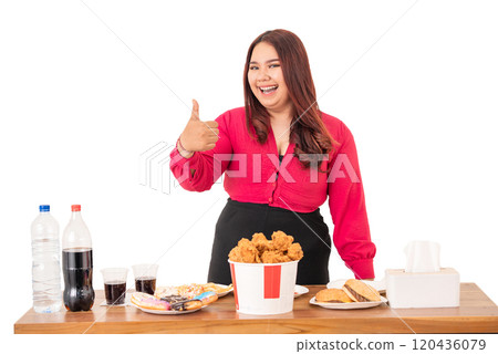 A Joyful Woman Delighting in Fast Food while Savoring Drinks and Snacks A Joyful Woman Delighting in Fast Food while Savoring Drinks and Snacks 120436079