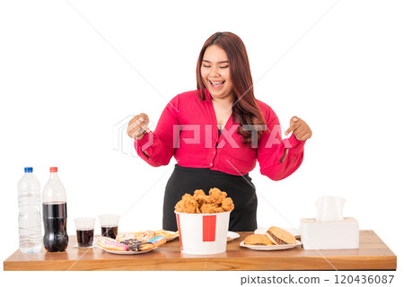 Excited Woman Happily Enjoying a Lavish Feast Filled with Fried Chicken and Snacks 120436087