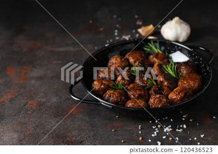 Meatballs in a black bowl on a dark background 120436523