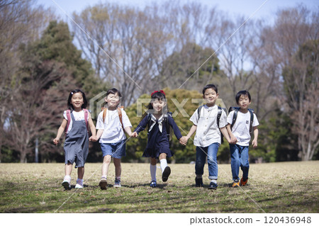 Five first graders carrying their school bags Five first graders carrying their school bags 120436948