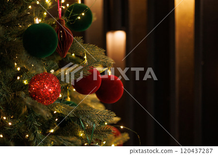 Close-up of a Christmas tree with red balls and bokeh in the background. Close-up of a Christmas tree with red balls and bokeh in the background. 120437287