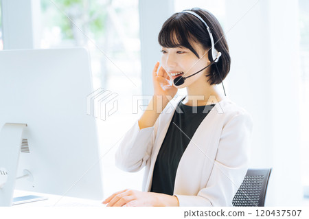 Female operator working at a call center 120437507