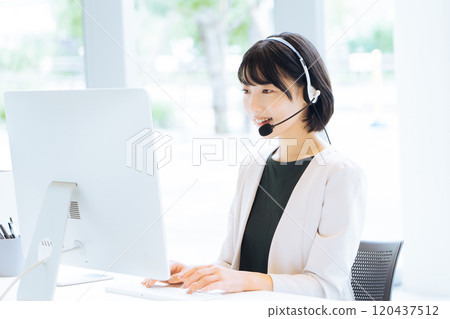 Female operator working at a call center 120437512