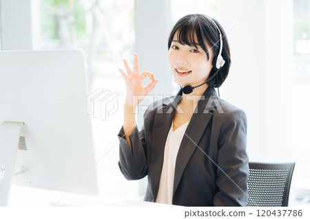 Female operator working at a call center Female operator working at a call center 120437786