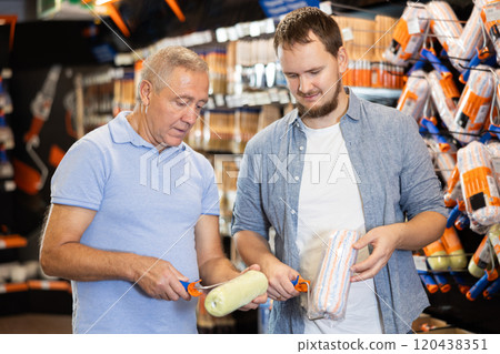 Senior man and guy choose brush and painting roller and selects desired option 120438351