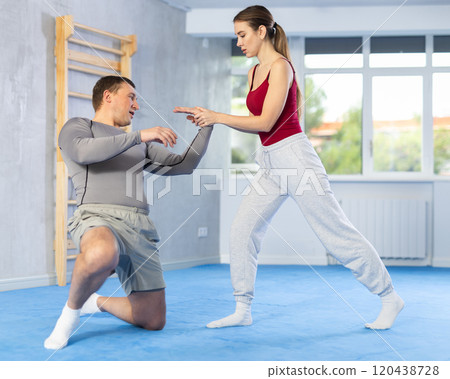 Woman and man practicing self defense techniques Woman and man practicing self defense techniques 120438728