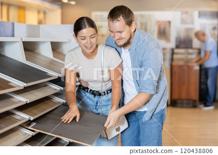 Couple man and woman choosing laminate sample 120438806