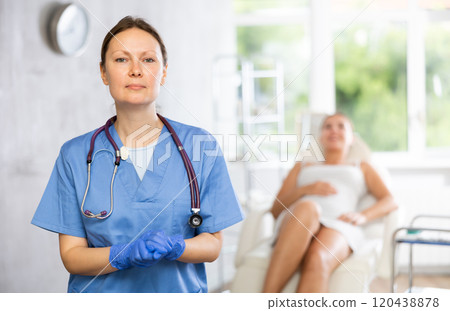Adult female doctor posing in medical room Adult female doctor posing in medical room 120438878