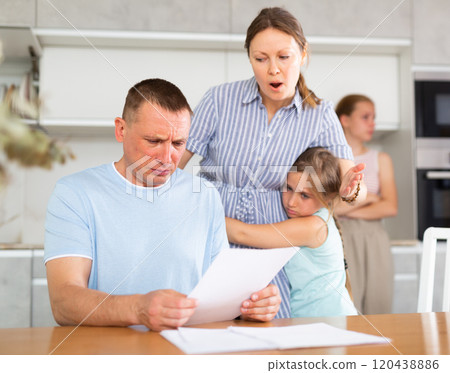 Wife yells at her husband who has not paid the loan. Children upset and scared Wife yells at her husband who has not paid the loan. Children upset and scared 120438886