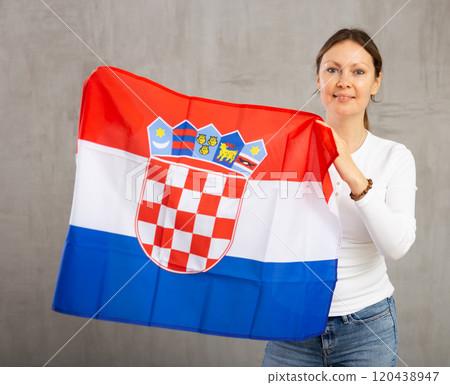 Smiling woman posing with national flag of Croatia in studio 120438947