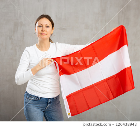 Frustrated woman holding flag of Austria. Fear and upset for mistake 120438948
