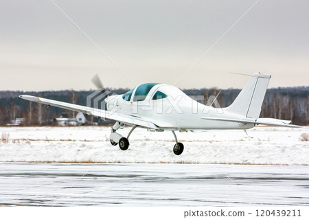 Takeoff the small sport airplane at winter airfield 120439211