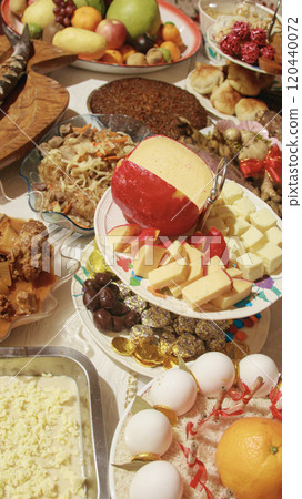 A festive table filled with a variety of local traditional Filipino dishes with the queso de bola or cheese ball as centerpiece for the New year media noche meal celebration in the Philippines 120440072