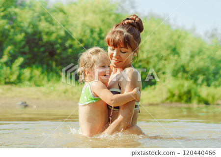 mom and child swim in the river 120440466