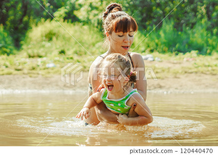mom and child swim in the river mom and child swim in the river 120440470