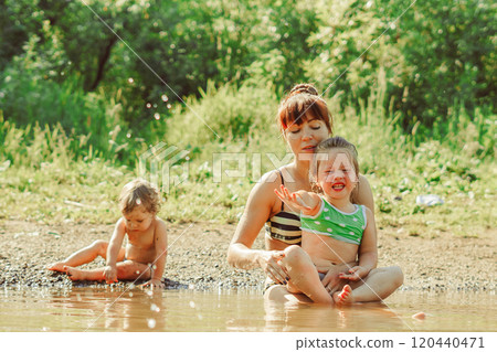 mom and child swim in the river mom and child swim in the river 120440471