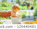 A little boy is bathing in a basin 120440481