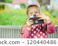 A little girl with a camera 120440486
