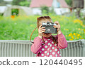 A little girl with a camera 120440495