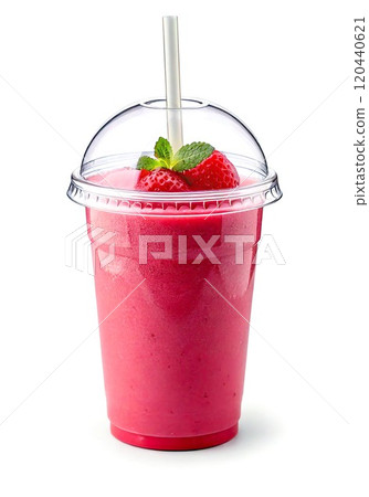 Delicious strawberry smoothie served in a clear cup with a straw and mint garnish. 120440621